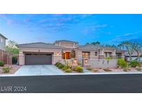 Inviting single-story home featuring a well-manicured front yard and a two-car garage at 1732 Cypress Manor Dr, Henderson, NV 89012