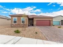 Charming single-story home with a brick driveway and a desert landscape at 1838 Classic Novel St, Las Vegas, NV 89115