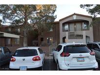 A multi-story condominium building featuring dual entrances and ample parking at 2121 Sealion Dr # 105, Las Vegas, NV 89128