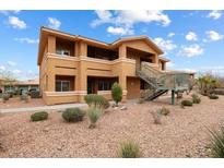 Inviting two-story condo with stucco exterior, desert landscaping, and convenient stair access at 313 Haley Way # D, Mesquite, NV 89027