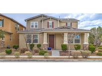 Charming two-story home with a well-maintained yard and inviting front porch at 3237 Mist Effect Ave, Henderson, NV 89044