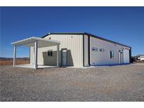 Metal clad building with attached carport in desert landscape at 3341 S Big Sky Way, Pahrump, NV 89048