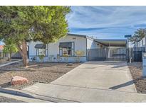 Charming single-story home featuring a well-maintained yard and a convenient covered parking area at 518 Topaz Ave, Henderson, NV 89015