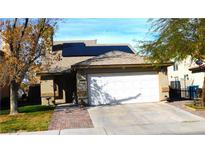 Charming one-story home featuring a two-car garage, solar panels, and a well-maintained front yard at 5856 Sutcliffe Cir, Las Vegas, NV 89110