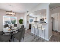 Bright dining area and kitchen featuring an open layout, stainless steel appliances, and modern countertops at 6160 Rumrill St # 201, Las Vegas, NV 89113