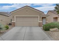 Charming single-story home with a two-car garage and well-maintained landscaping at 7705 Lily Trotter St, North Las Vegas, NV 89084