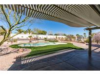 Inviting backyard with a pool, covered patio, and ample space for entertaining guests at 9816 Gerald Ct, Las Vegas, NV 89134