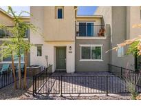 Charming townhome featuring a cozy front patio with iron fencing and desert landscaping at 2598 Mocha Pearl Ct, North Las Vegas, NV 89086