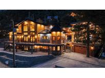 Stunning multilevel mountain home featuring balconies, stone accents, and a two-car garage at 306 Crestview Dr, Las Vegas, NV 89124