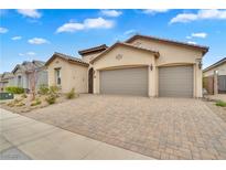 Attractive single-story home boasts a paver driveway and a two-car garage, offering comfortable and stylish living at 330 Meadow Brush Pl, Henderson, NV 89011