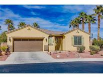 Inviting single-story home features a well-manicured front yard with desert landscaping and a two-car garage at 4204 Sunset Falls Ave, North Las Vegas, NV 89085