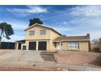 Two-story home with a two-car garage, desert landscaping and stairs leading to the front door at 4300 Don Quixote St, Las Vegas, NV 89121