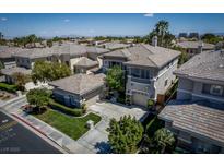 An aerial view of a two story stucco home featuring tile roof, balcony, and landscaped surroundings at 504 Pinnacle Heights Ln, Las Vegas, NV 89144