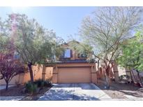 Charming two-story home featuring a well-maintained front yard and a two-car garage, offering curb appeal and convenience at 7403 Benlomond Ave, Las Vegas, NV 89179