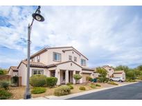 Charming two-story home featuring desert landscaping, a two-car garage, and a welcoming covered entry at 7877 Campers Village Ave, Las Vegas, NV 89178