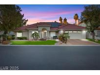 Charming single-story home featuring a tile roof, well-manicured lawn, and desert landscaping at 7944 Marbella Cir, Las Vegas, NV 89128