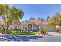Charming single-story home with desert landscaping, tile roof, and arched entryway at 7944 Marbella Cir, Las Vegas, NV 89128