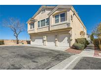 Inviting townhouse featuring three garage spaces and a light stucco exterior, perfect for modern living at 9314 Indian Corn Ct # 102, Las Vegas, NV 89178