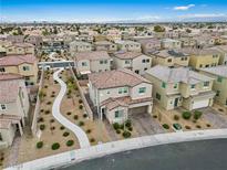 An aerial view of a residential area shows multiple two-story homes with landscaped yards and walkways at 2205 Stone Well Rd, North Las Vegas, NV 89031