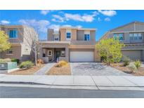 Contemporary two-story home featuring a two-car garage and low-maintenance landscaping at 2450 Sylvan Hymn St, Henderson, NV 89044