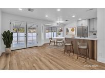 Open-concept kitchen features modern appliances, a breakfast bar, and sliding glass doors to the backyard at 3104 Waterview Dr, Las Vegas, NV 89117