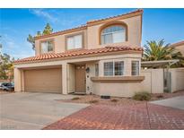 Two story home with a terracotta tile roof, stucco siding, and a two car garage at 3331 Cheltenham St, Las Vegas, NV 89129
