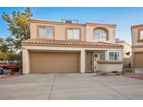 Charming two-story townhome featuring a two-car garage, tiled roof, and neutral stucco exterior at 3331 Cheltenham St, Las Vegas, NV 89129