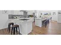 Bright kitchen boasts marble countertops, stainless steel appliances, and a large island with bar seating at 3492 Edison Ave, Las Vegas, NV 89121