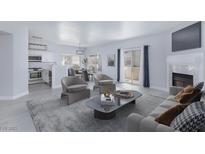 Bright living room featuring modern furnishings, fireplace, and an open floor plan at 4820 Grey Wolf Ln # 101, Las Vegas, NV 89149