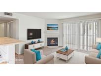 Bright living room with a fireplace and sliding glass doors, offering lots of light at 5265 Caspian Springs Dr # 201, Las Vegas, NV 89120