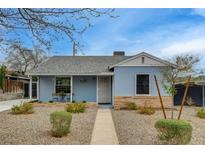 Charming single-story home with a blue facade, well-kept landscaping, and a welcoming walkway at 533 K Ave, Boulder City, NV 89005