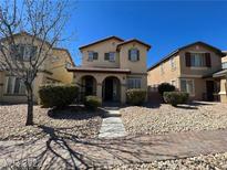 Charming two-story home featuring manicured front yard, desert landscaping, and covered porch at 5721 Heineken Dr, North Las Vegas, NV 89031