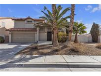 Inviting two-story home with desert landscaping and a two-car garage offers curb appeal at 5850 Grey Wood Way, North Las Vegas, NV 89031