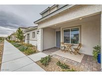 Cozy front porch with small table and chairs creates a welcoming entrance and curb appeal at 6178 Foxes Dale St, Las Vegas, NV 89166