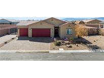 Charming single-story home featuring a desert landscape and a three-car garage at 91 Hawk Ave, Pahrump, NV 89060