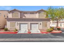 Inviting townhome featuring a two-car garage, tidy landscaping, and a well-maintained facade at 9555 Belle Fountain Ave, Las Vegas, NV 89123