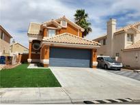 Charming two-story home with landscaped front yard and two-car garage in a suburban neighborhood at 1208 Lucia Dr, Las Vegas, NV 89128