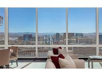 Bright living room with floor to ceiling windows offering spectacular views of the Las Vegas skyline at 2000 Fashion Show Dr # 6109, Las Vegas, NV 89109