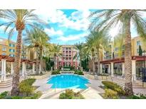 Resort style pool with surrounding palms, covered seating areas and luxurious condos at 30 Strada Di Villaggio # 118, Henderson, NV 89011