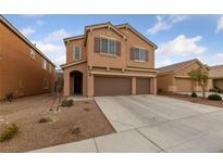 Inviting two-story home featuring a three-car garage, neutral tones, and well-kept landscaping at 3718 True Spring Pl, North Las Vegas, NV 89032