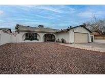 Charming single-story home featuring a low-pitched roof, arched entry and a two-car garage at 4323 E Twain Ave, Las Vegas, NV 89121