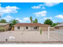 Charming single-story home featuring desert landscaping and a two-car garage under a blue sky at 57 Marion Dr, Las Vegas, NV 89110