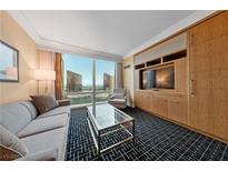 Comfortable living room with a city view and built in cabinets and entertainment center at 2000 N Fashion Show Dr # 3307, Las Vegas, NV 89109