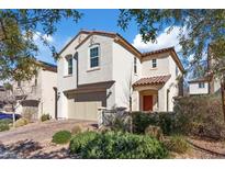 Charming two-story home featuring a tile roof, stucco exterior, and a well-manicured front yard at 460 Accelerando Way, Henderson, NV 89011