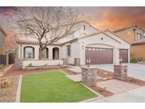 Charming two-story stucco home with a well-manicured lawn, mature tree, and a three-car garage at 7466 Matilda St, Las Vegas, NV 89113