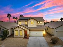 Charming two-story home with desert landscaping and solar panels set against a colorful twilight sky at 7652 Borealis St, Las Vegas, NV 89123