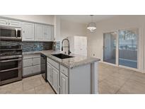 Bright kitchen boasts stainless steel appliances, modern countertops, and a stylish backsplash at 2251 Wigwam Pkwy # 314, Henderson, NV 89074