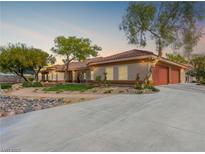 Beautiful home exterior featuring a long driveway, mature landscaping, and a red tile roof at 5340 N Campbell Rd, Las Vegas, NV 89149