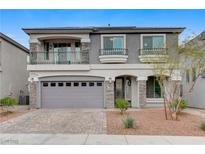 Charming two-story home featuring a brick driveway, gray exterior, and a cozy balcony, showcasing a welcoming facade at 6618 Tangled Vines Ave, Las Vegas, NV 89139