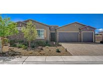 Beautiful single-story home featuring stone accents, desert landscaping, and a spacious three-car garage at 7119 Falabella Ridge Ave, Las Vegas, NV 89131